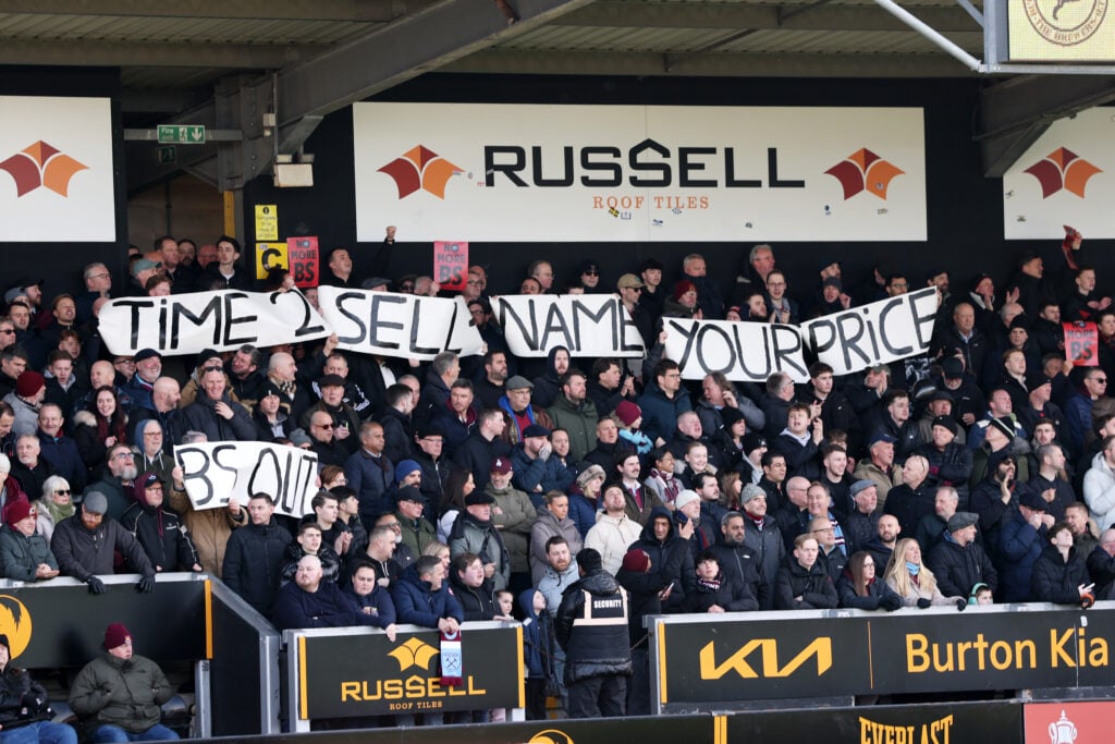 West Ham fans hold a banner that reads "Time to sell. Name your price. BS out" during their FA Cup game with Burton.