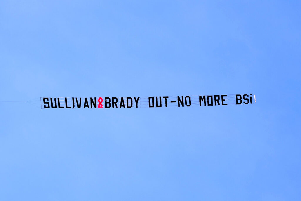 A plane displaying a banner with a message in protest to West Ham chief David Sullivan and Baroness Karren Brady