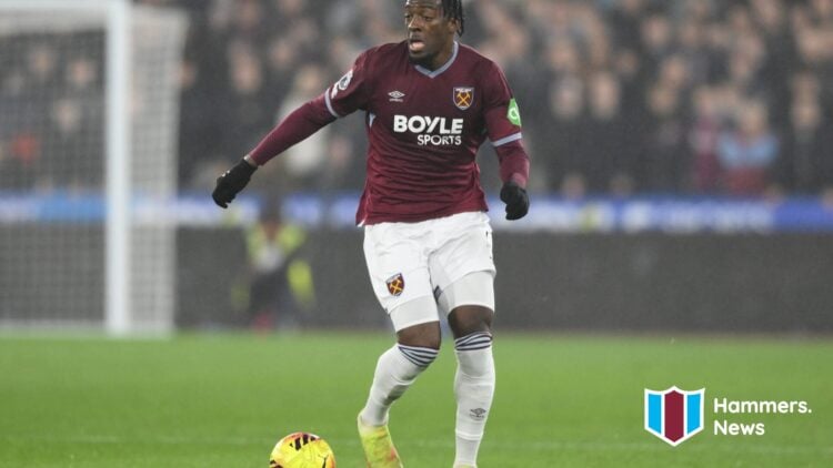 Axel Disasi runs with the ball during West Ham United vs Manchester United. A 'Hammers News' logo has been added.