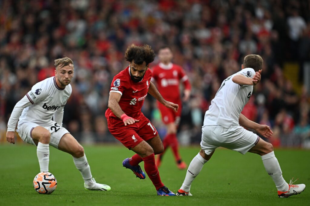 Liverpool's Mohamed Salah (C) vies with West Ham United's #20 Jarrod Bowen (L) during the English Premier League football match between Liverpool and West Ham United