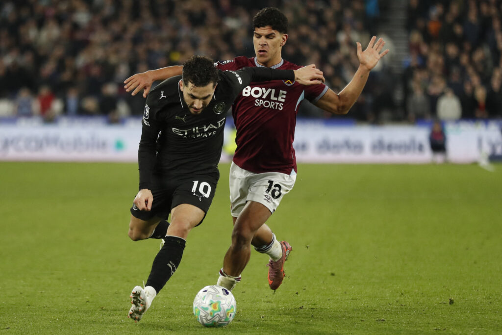 Rayan Cherki (L) vies with West Ham United's Portuguese midfielder #18 Mateus Fernandes