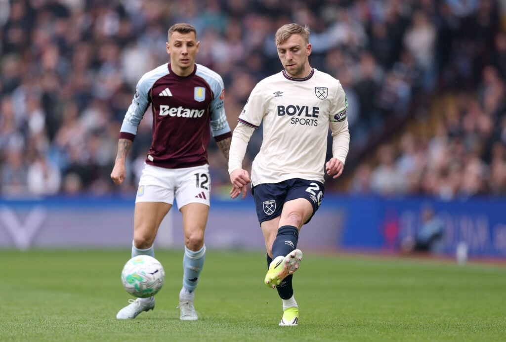 Jarrod Bowen of West Ham United passes the ball under pressure from Lucas Digne of Aston Villa during the Premier League match between Aston Villa and West Ham United