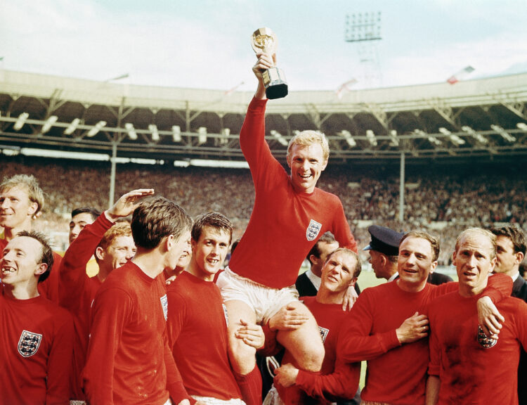 (Original Caption) 7/30/1966-England-: England captain Bobby Moore "chaired" by his team with the Jules Rimet Cup...after receiving it from the Que...