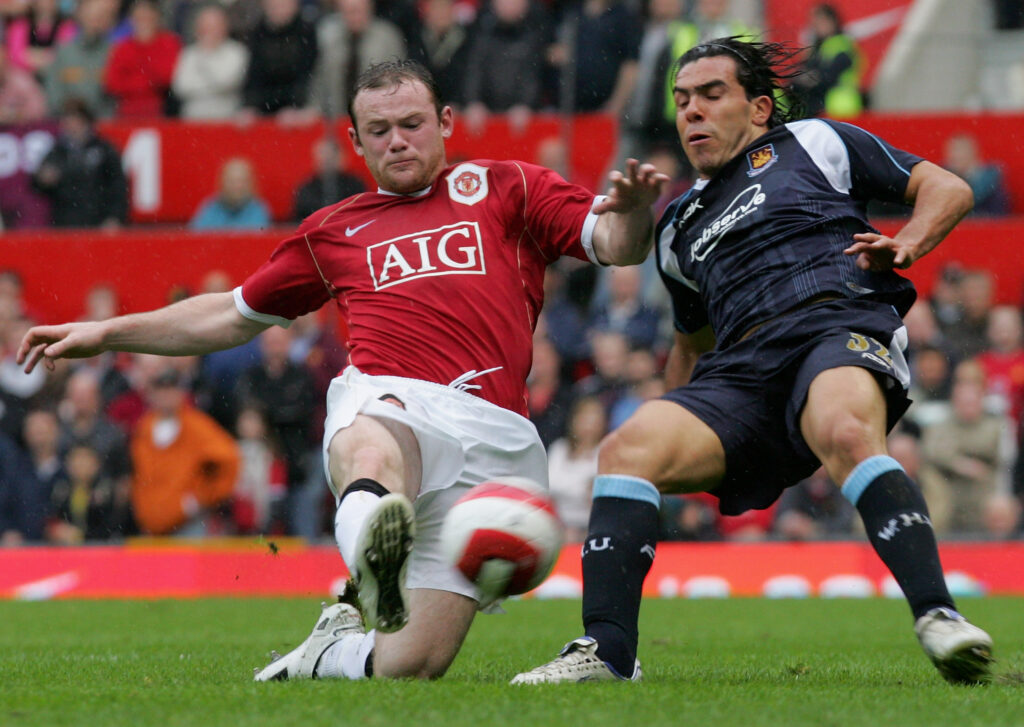 Wayne Rooney of Manchester United clashes with Carlos Tevez of West Ham United during the Barclays Premiership match between Manchester United and West Ham
