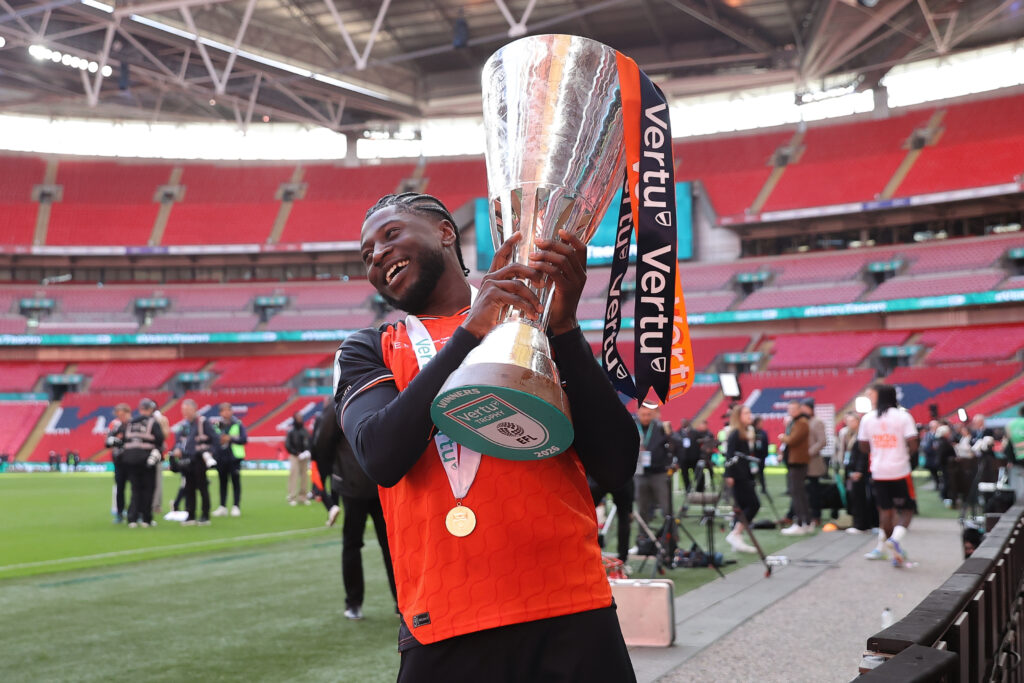 Gideon Kodua lifts the Vertu Trophy after Luton Town beat Stockport County in the final.