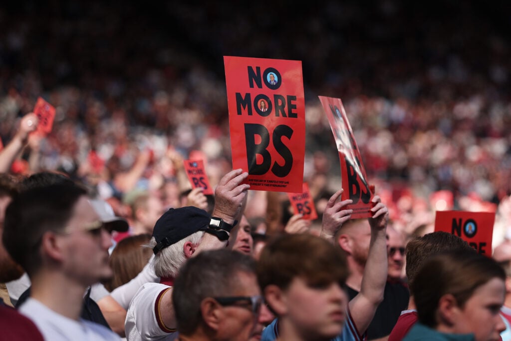 Fans of West Ham United hold up large red cards which read "No more BS" in protest of the clubs ownership during the Premier League match between West Ham United and Everton.