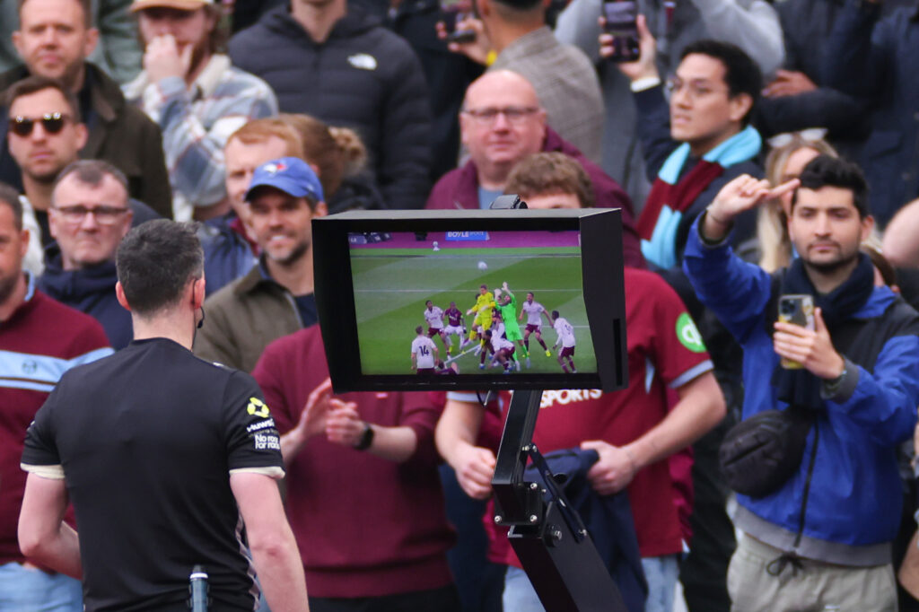 Referee Chris Kavanagh reviews VAR before disallowing a late goal from Callum Wilson during West Ham vs Arsenal FC.